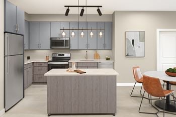 An open kitchen and dining area with a table and chairs and a refrigerator